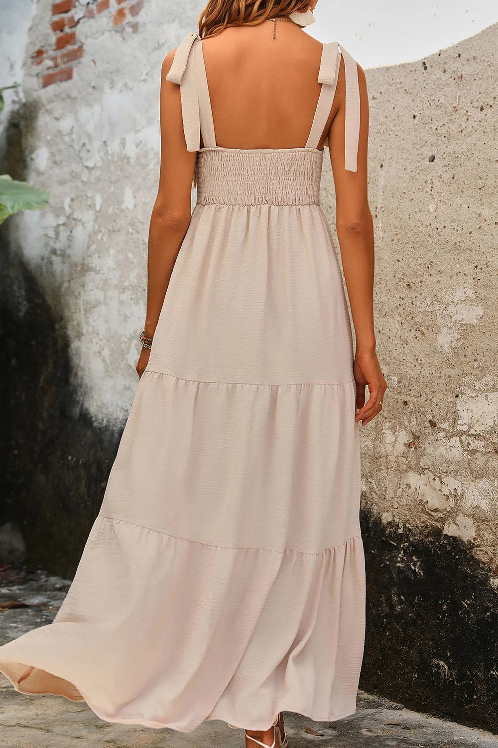 Model wearing  Perfee Tie Shoulder Smocked Tiered Dress- back view